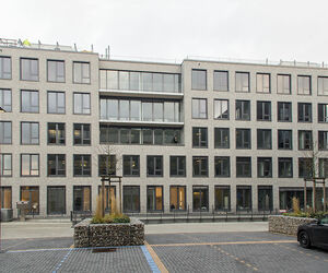Ockergraue Klinkerriemchenfassade und bodentiefe Aluminiumfenster